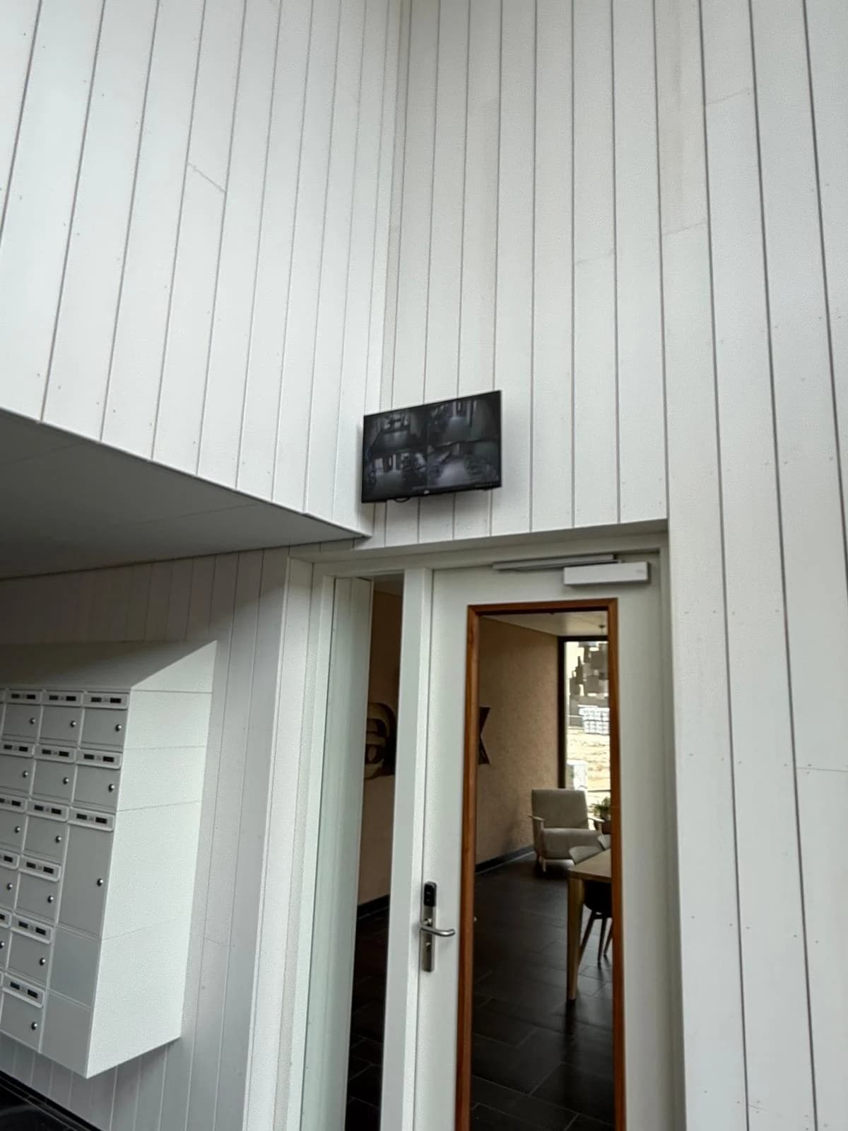 Live-beeldmonitor in hoofdentree VvE Alexliving Rotterdam met zicht op alle cameraposities
